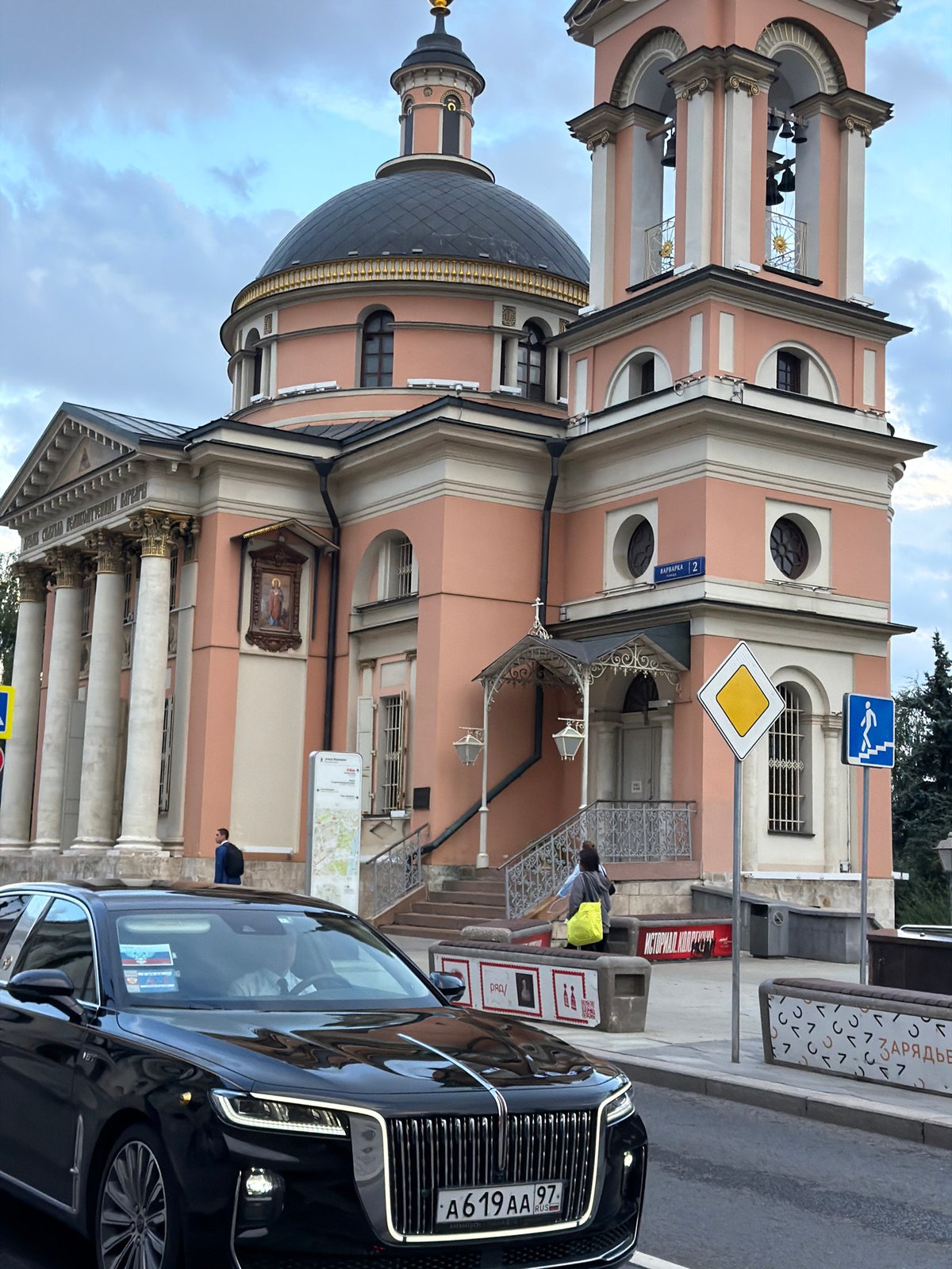 Russian-plated sedan parked near a pink domed church