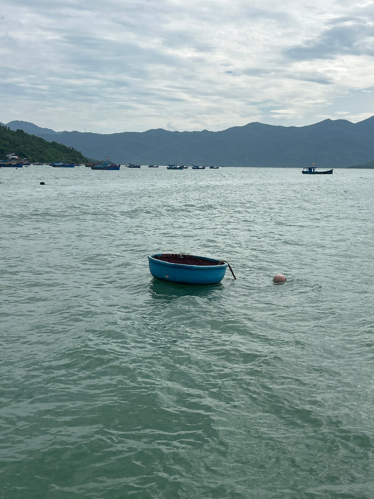 Fishing boats, speedboat, and ferry off the Vietnam coast