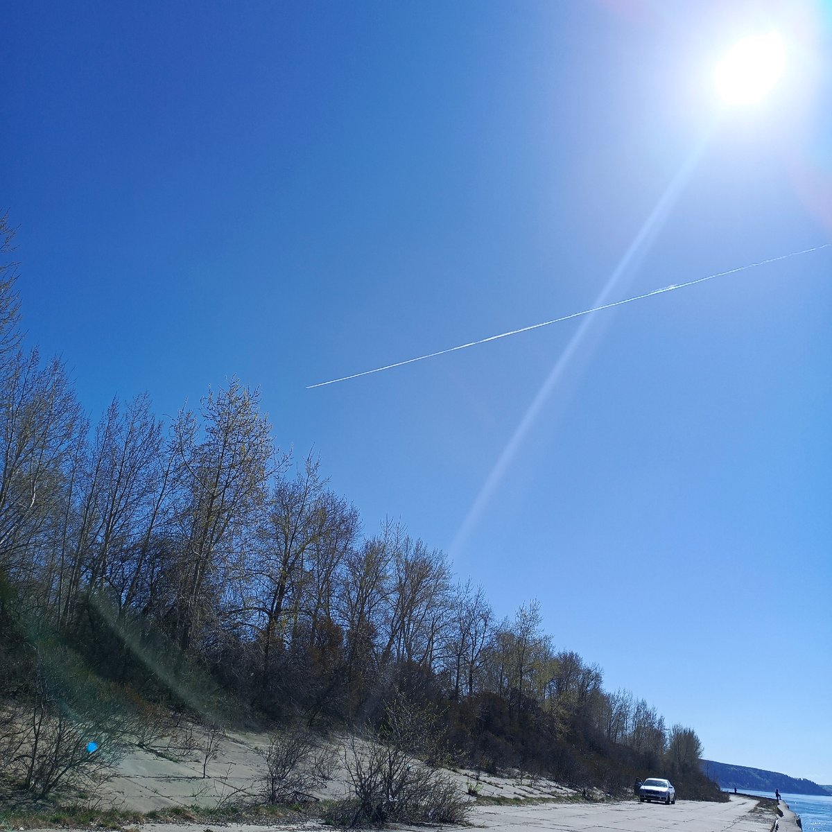 Woman and dog enjoy sunny morning along Kama River