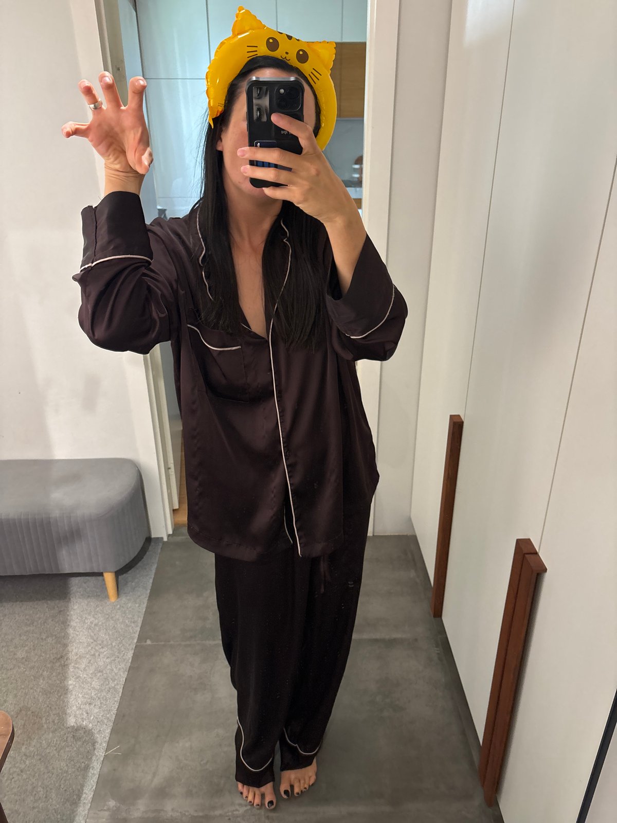 Person takes mirror selfie in cat-ear headband in Russia