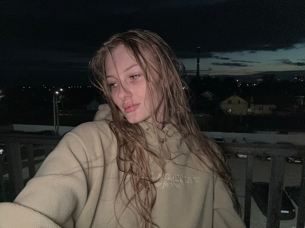 Woman captures dusk selfies on balcony in Kondratovo, Russia