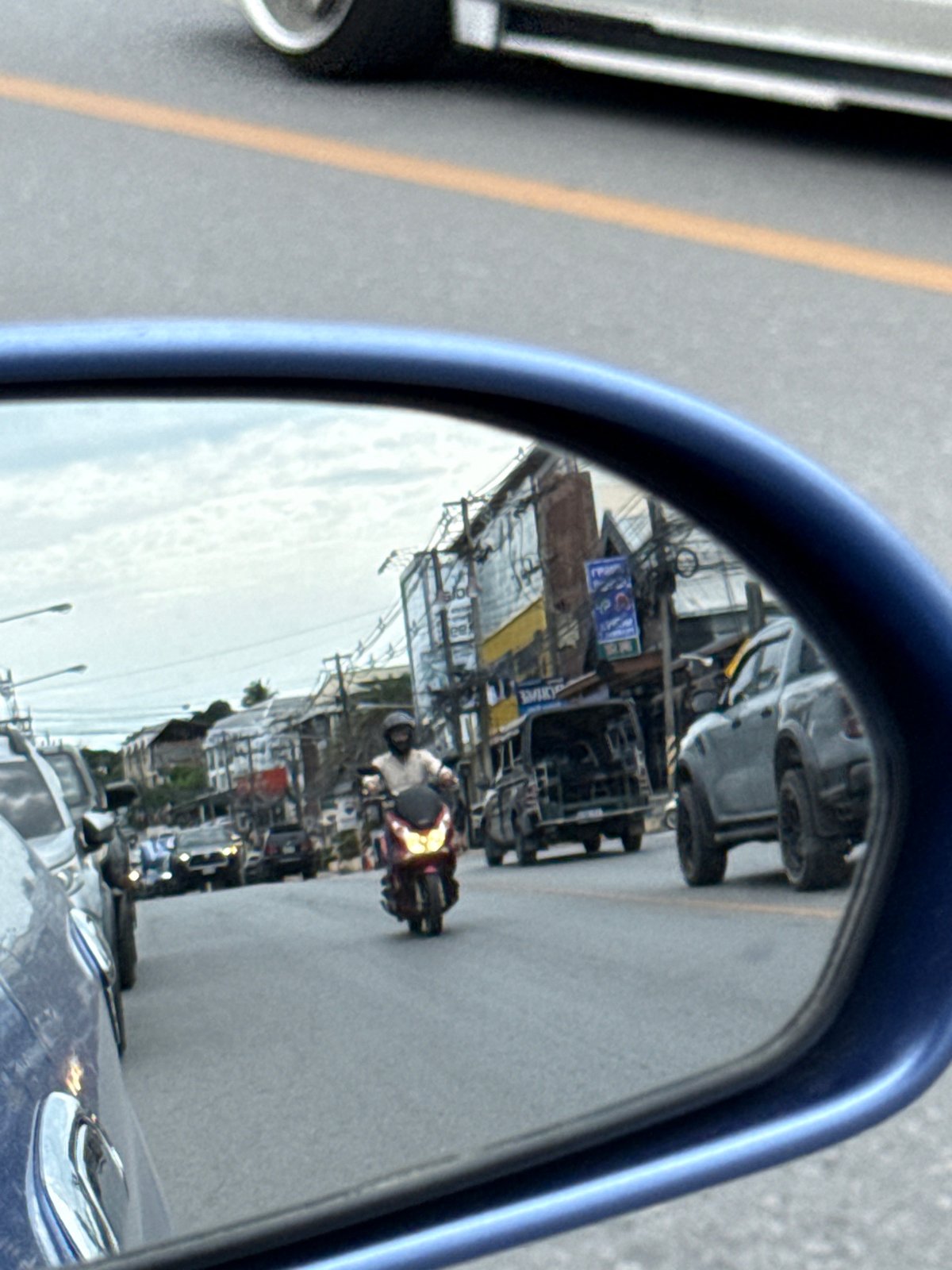 Morning traffic and a Lotus's billboard on Ko Samui streets
