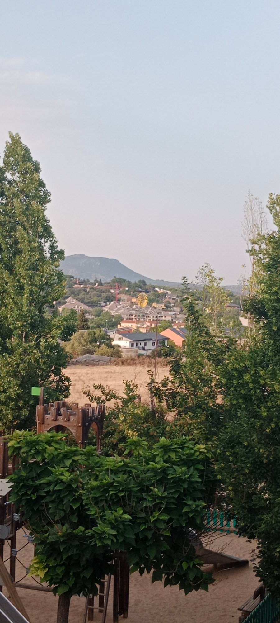 Galapagar hilltop viewpoint at dusk, town spread below