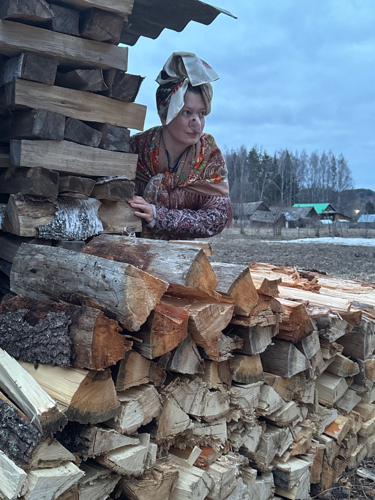 Rural Russians chop firewood in village of Вассята