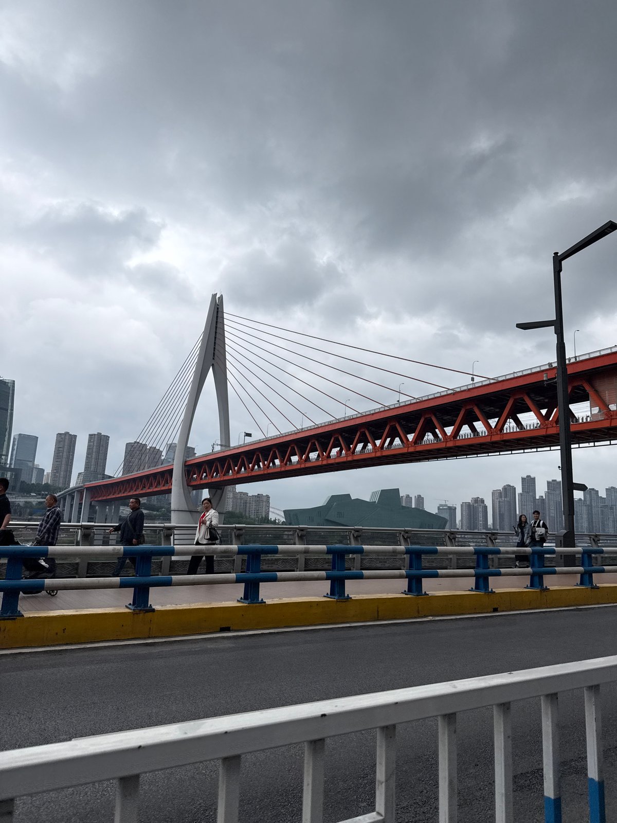 Pedestrian captures red bridge view in Yuzhong District