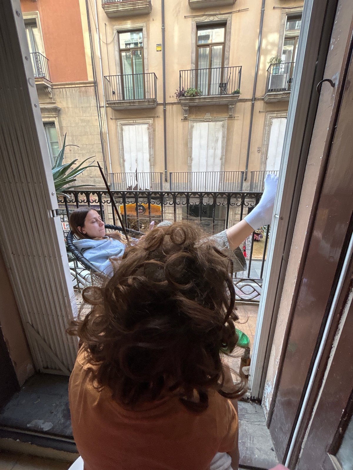 Person spotted on Barcelona balcony during afternoon leisure time