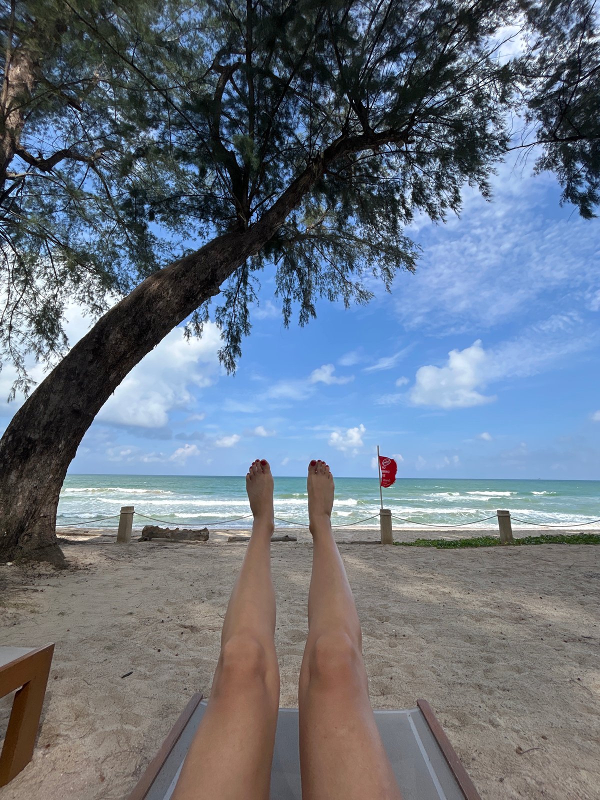 Relaxing beachside at a Choeng Thale resort with swimming restrictions posted