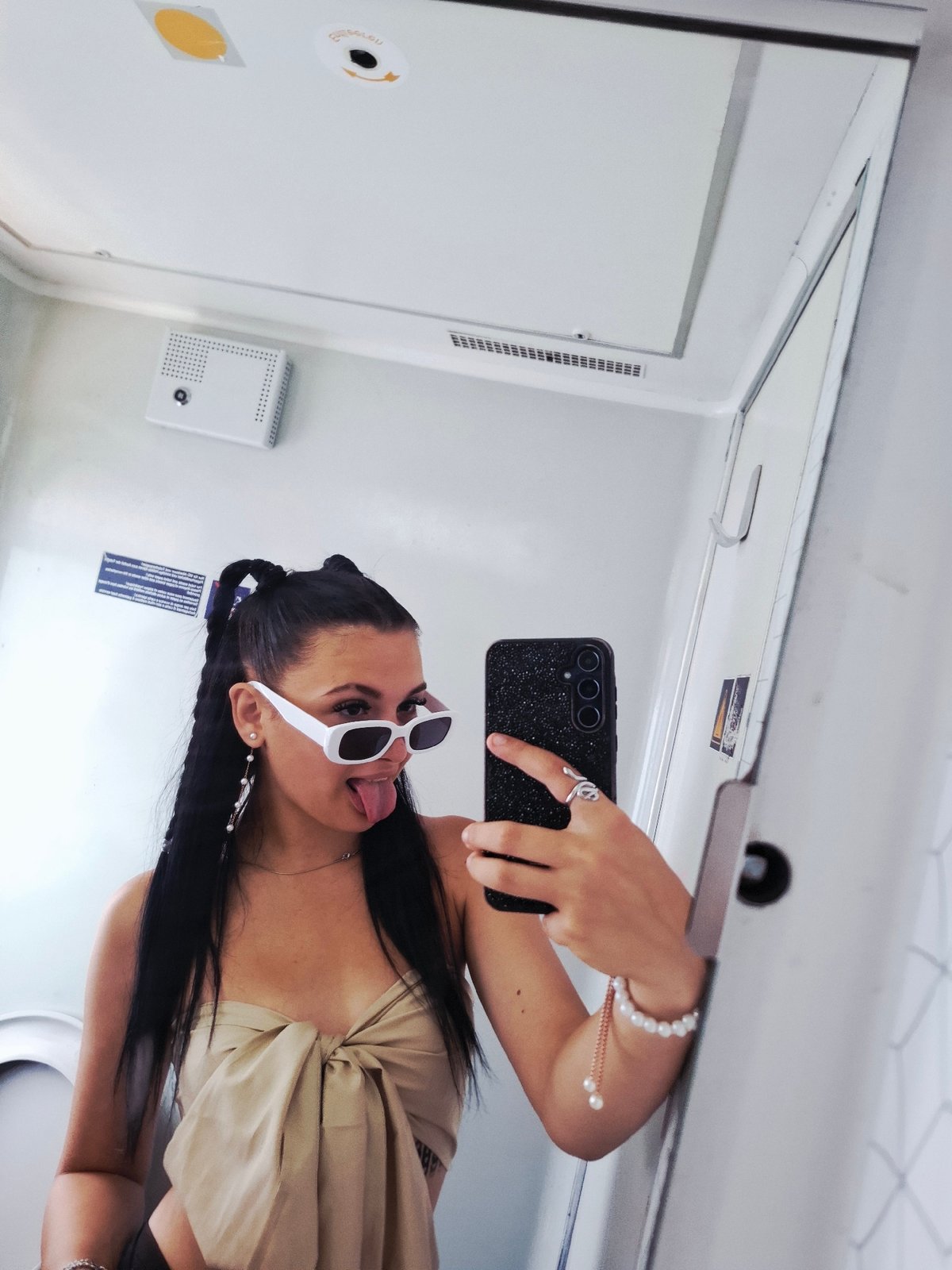 Woman takes playful selfie in transport restroom near Karlukovo