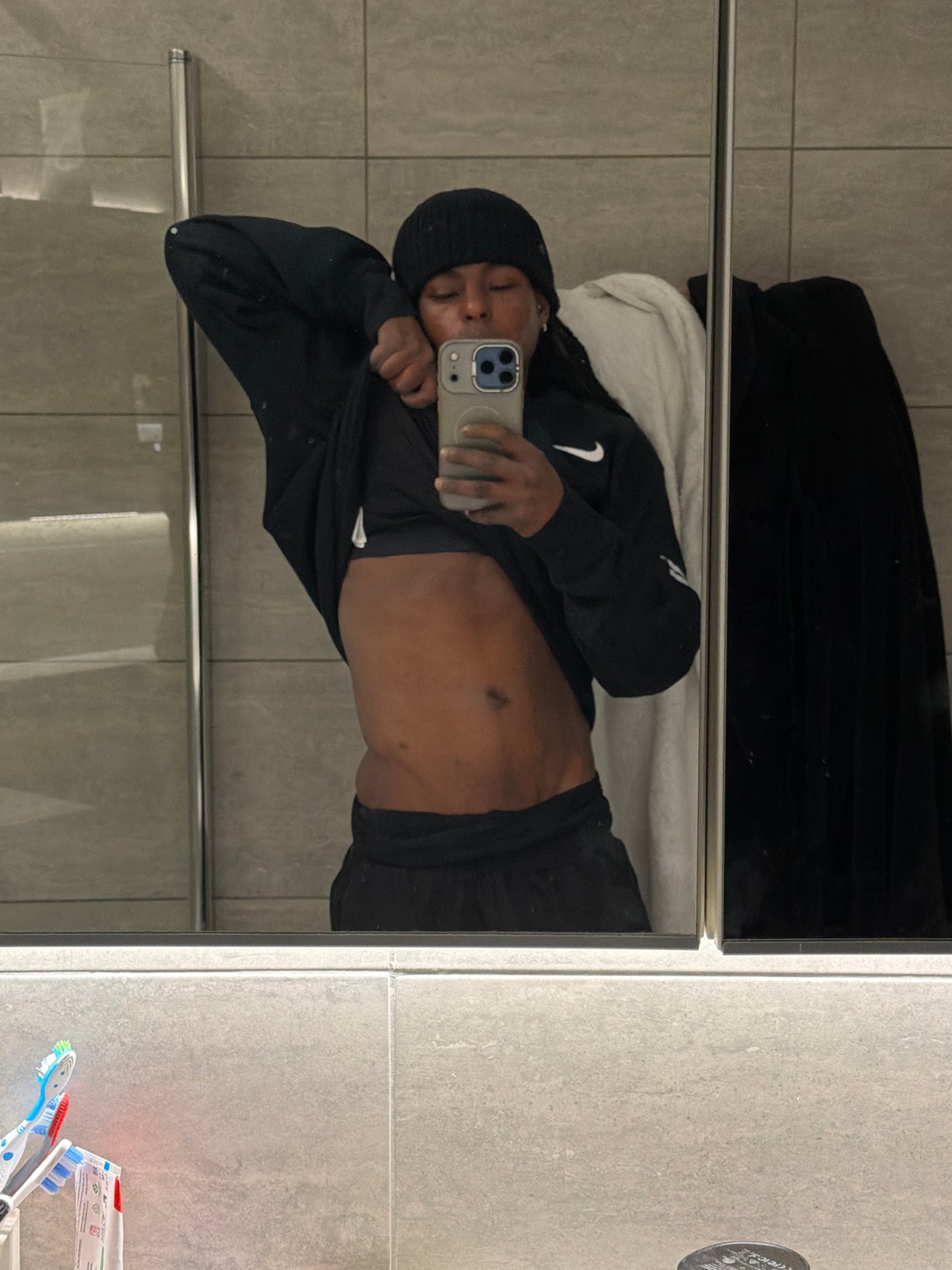 Person takes bathroom mirror selfies in London morning