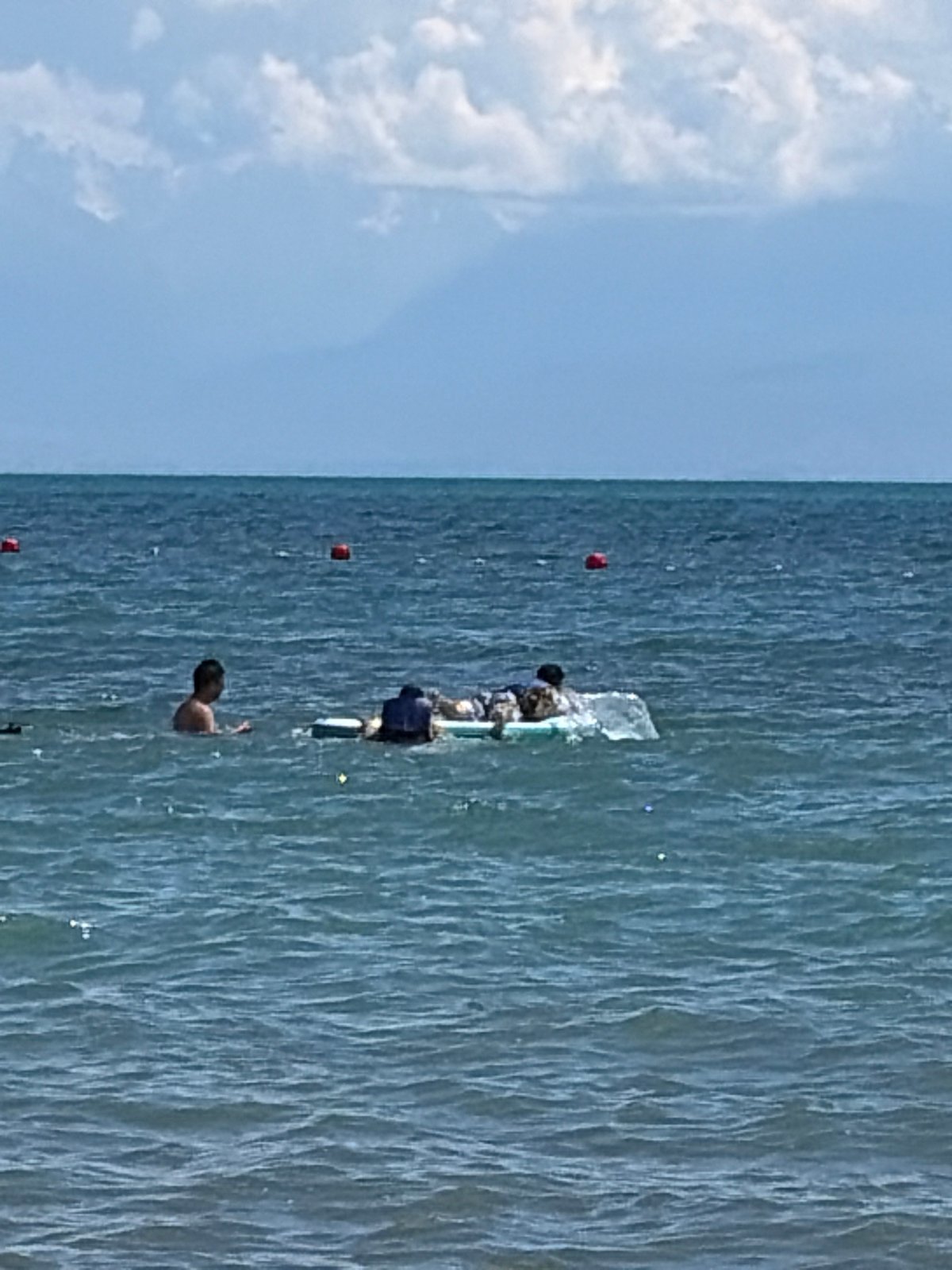 A relaxed beach day with swimming, paddleboarding, and shoreside lounging.