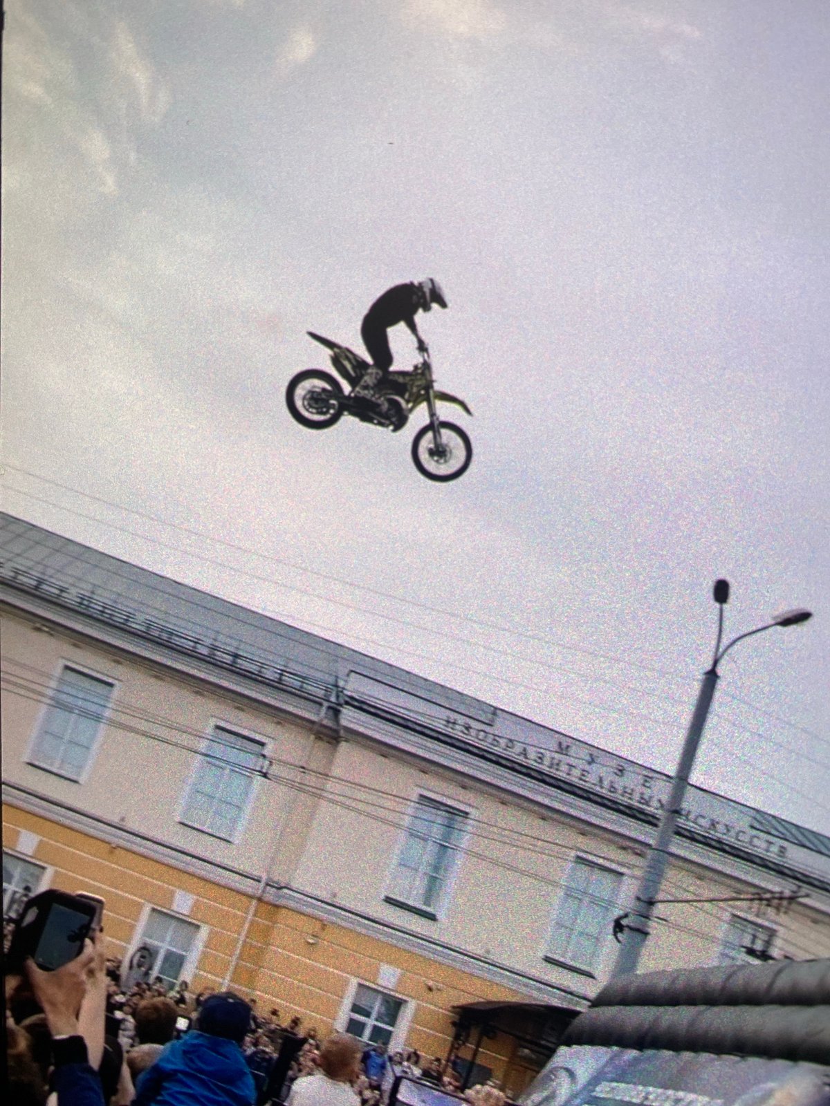 Motocross stunt jump against overcast sky backdrop