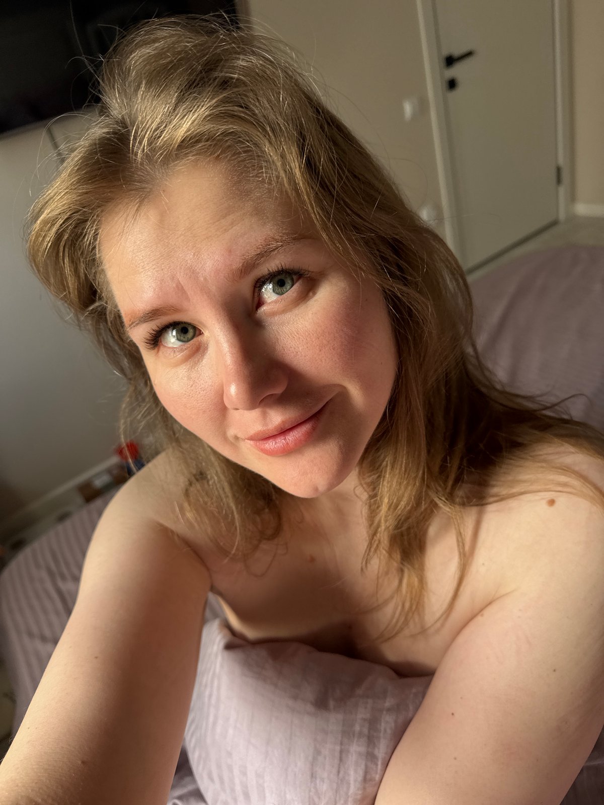 Woman photographed in bed during early morning hours in Russia