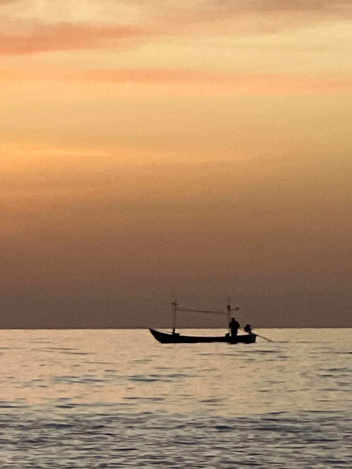 Fishing boat and beachgoers at dusk, Ko Pha-ngan