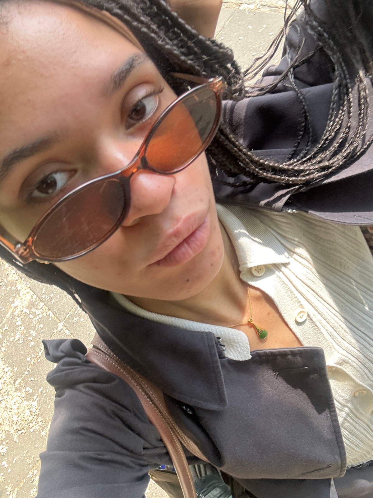 Woman in sunglasses photographed from ground level in London
