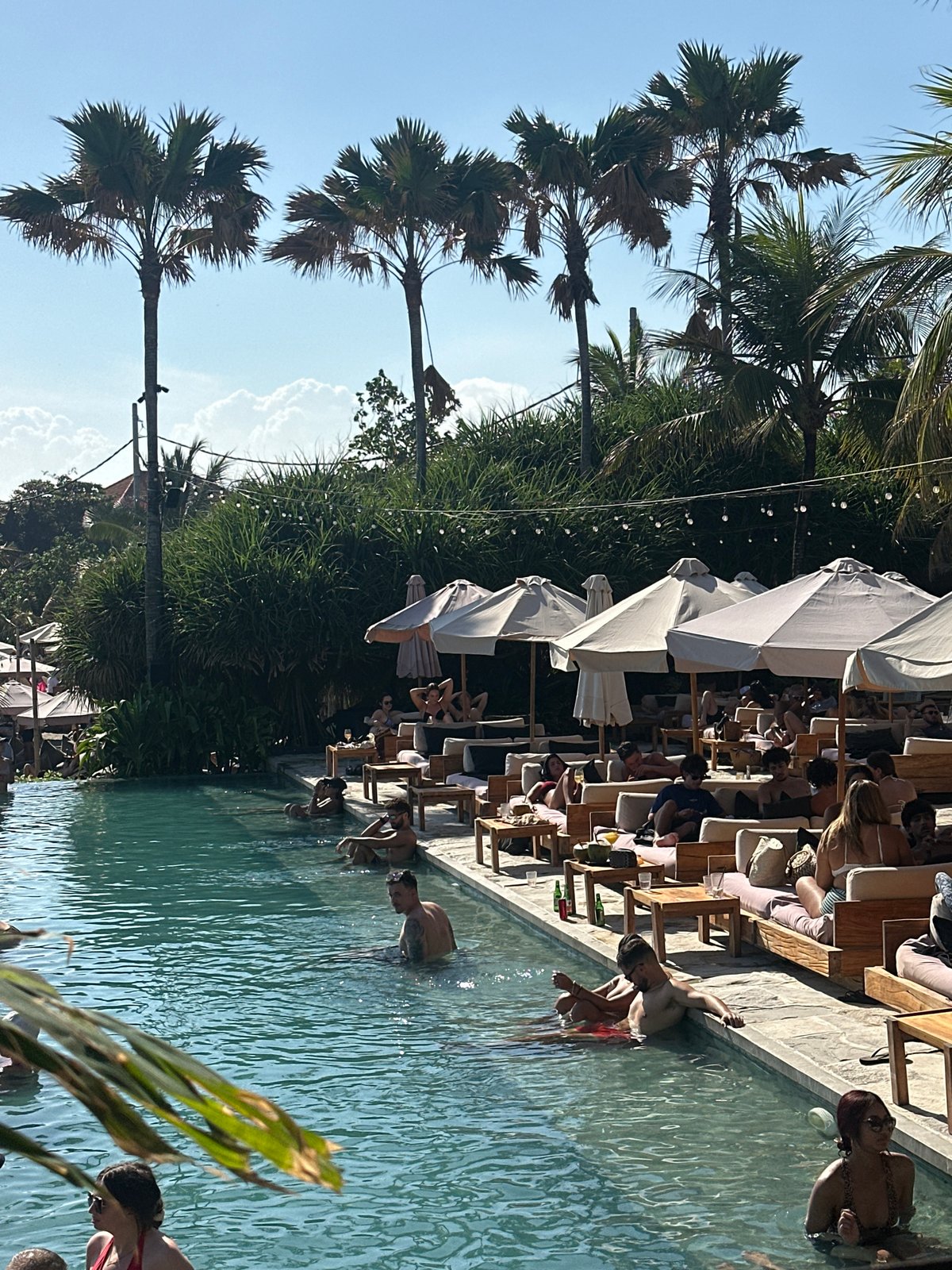 Beach club vibes with pool, DJ, and ocean views