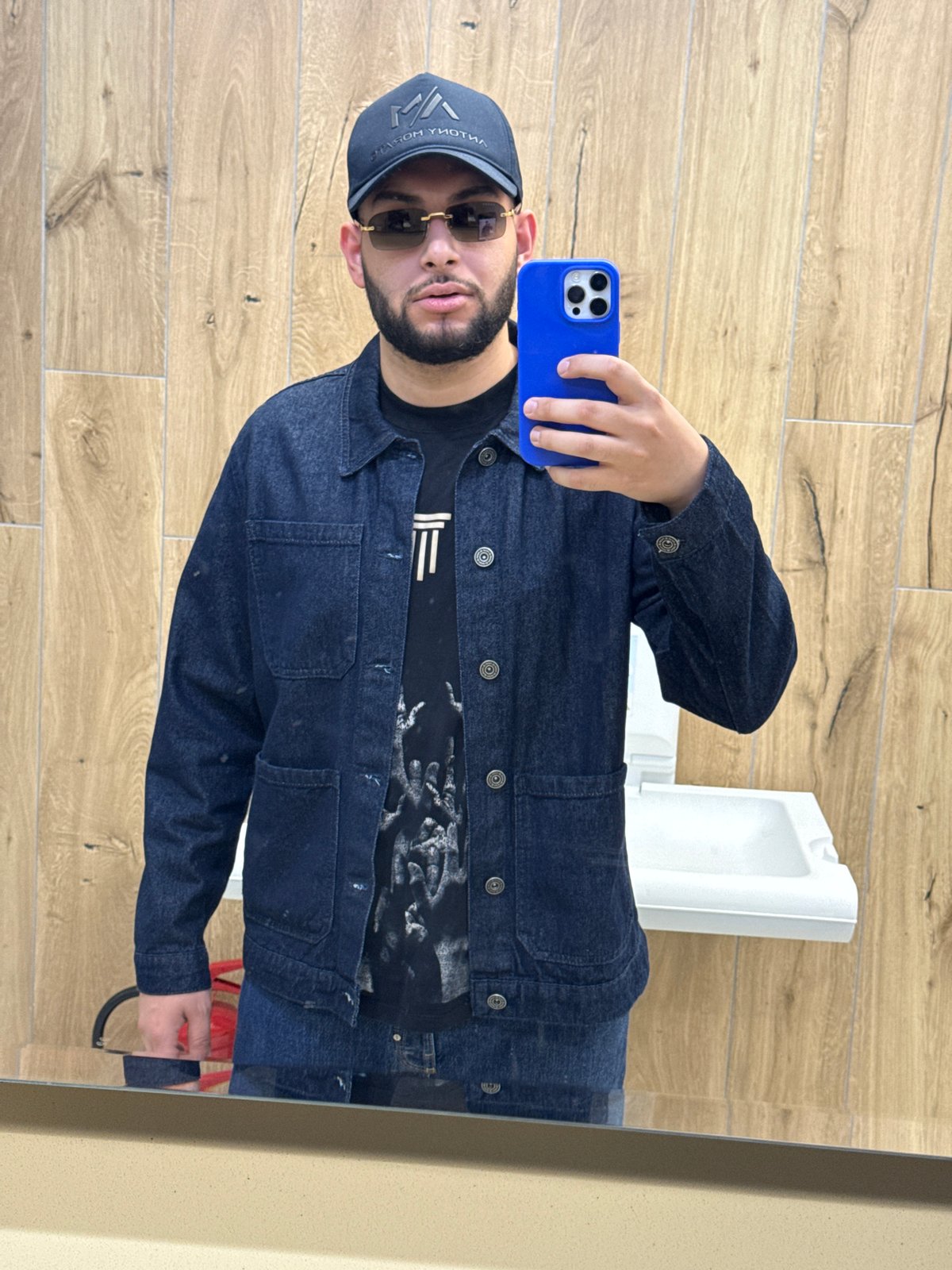 Person takes restroom selfie, drinks blue beverage in brief encounter