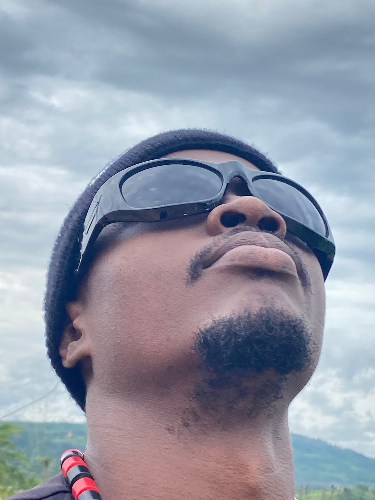 Man gazes at overcast sky in Ufueseni, Nigeria