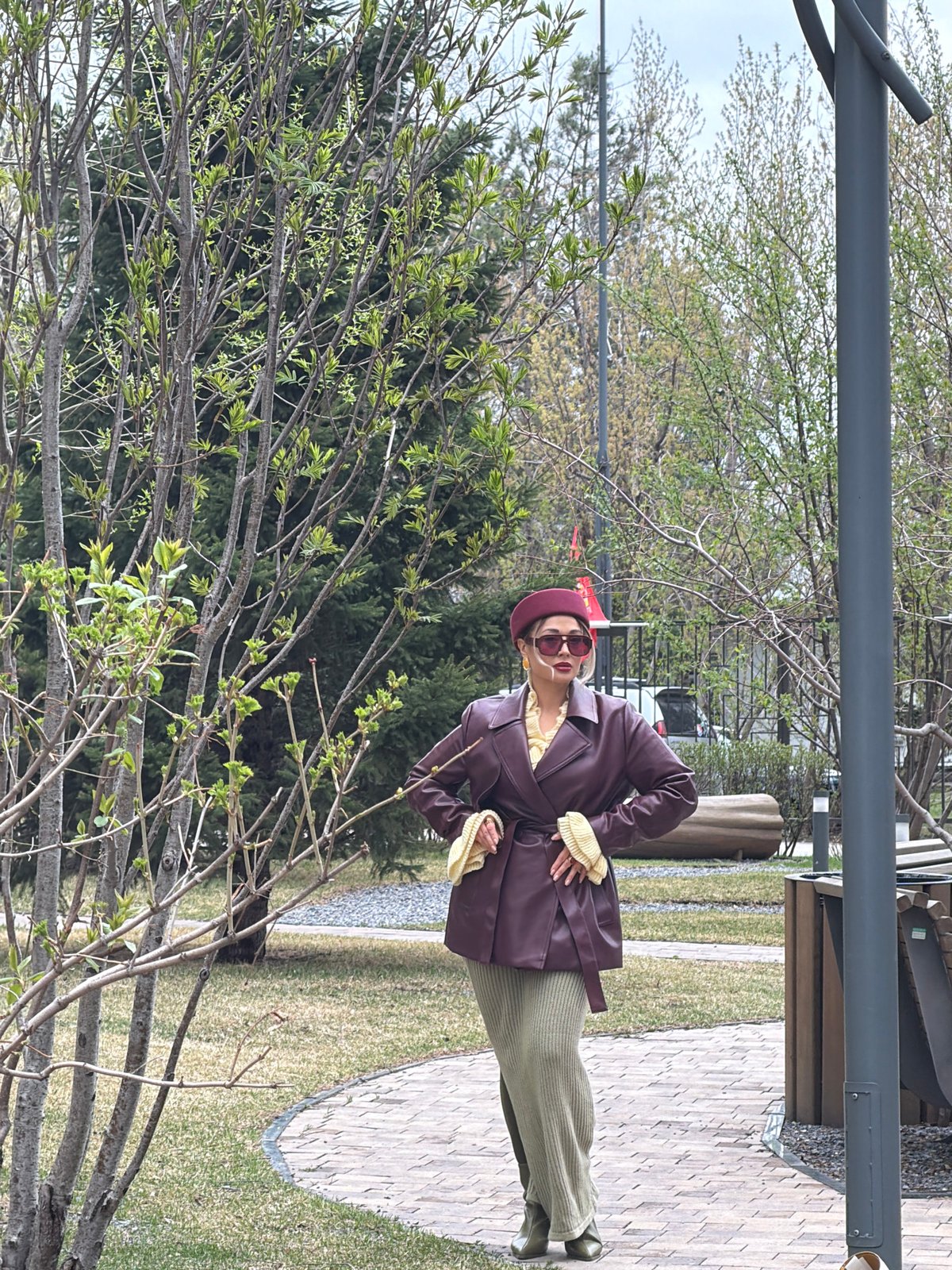 Woman in burgundy outfit photographed in Krasnoyarsk park