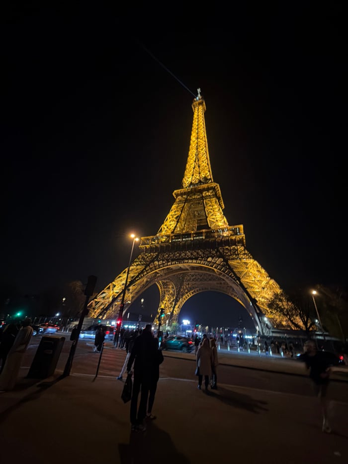 Illuminated Eiffel Tower draws crowds during Paris evening