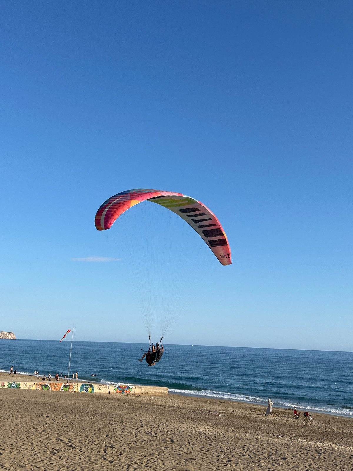 Paragliders soar over Kleopatra Beach in Alanya, Turkey