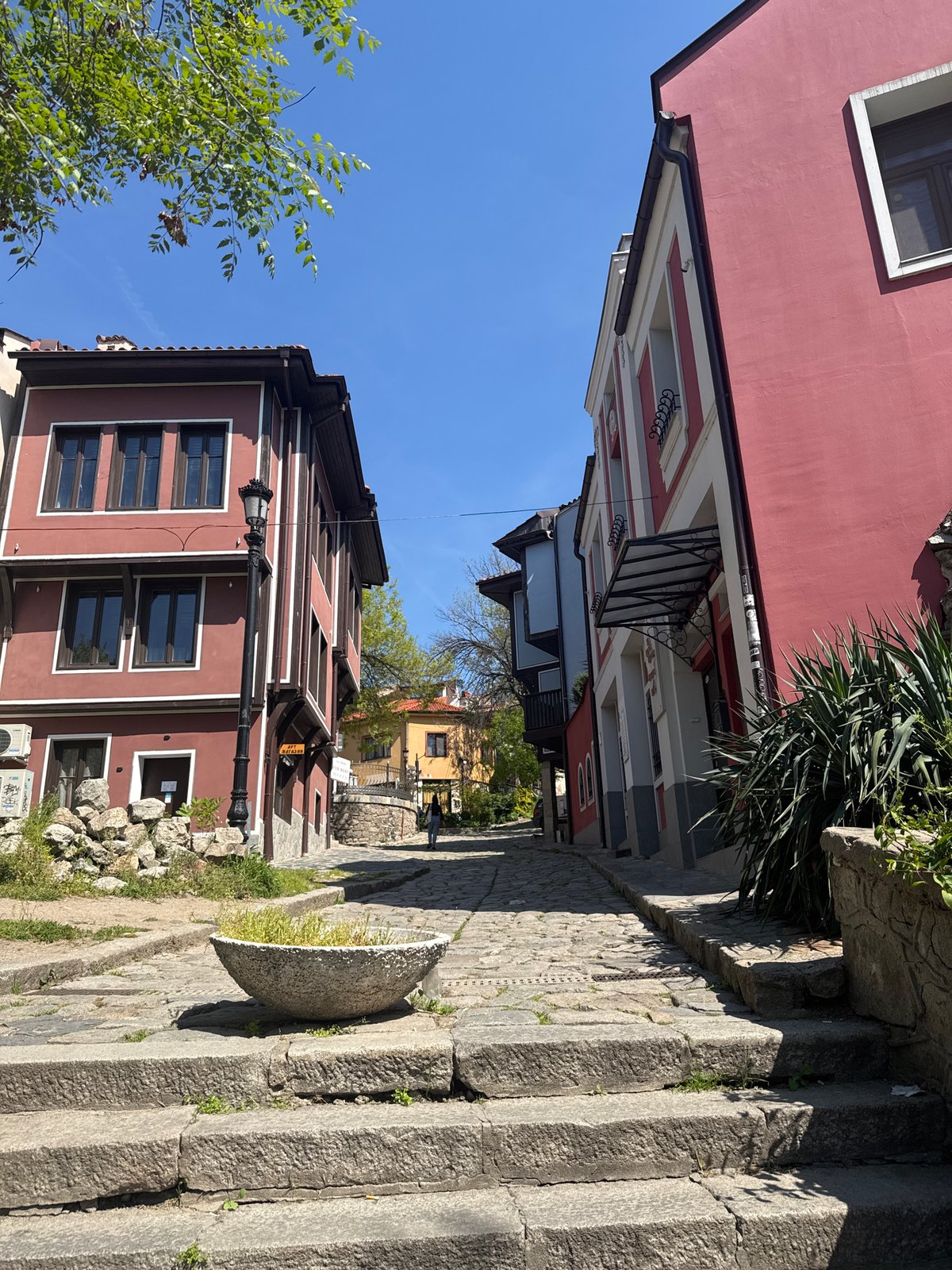 Tourists explore historic Plovdiv Old Town cobblestone streets