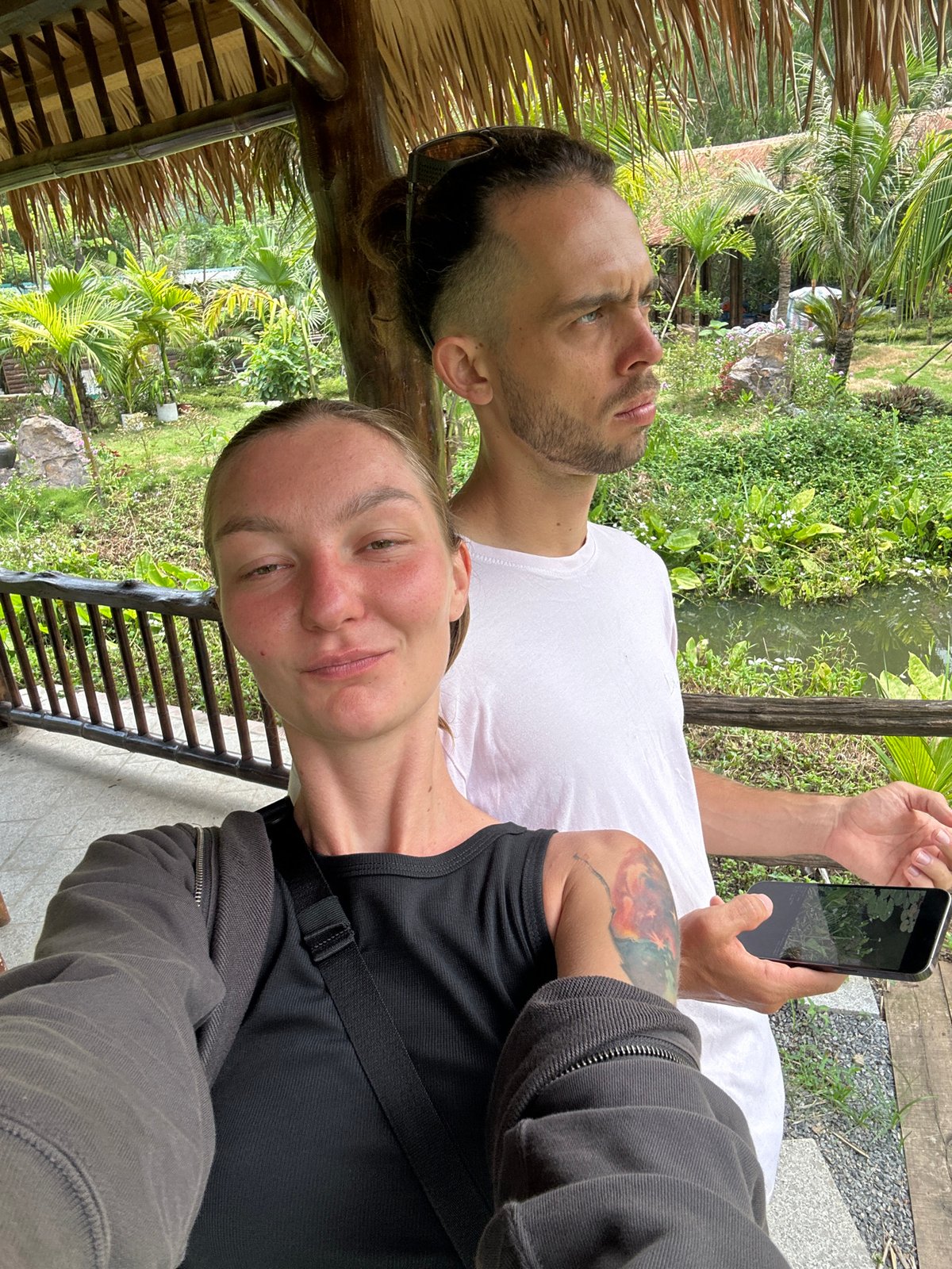 Woman photographs tropical resort visit in Vietnam early morning