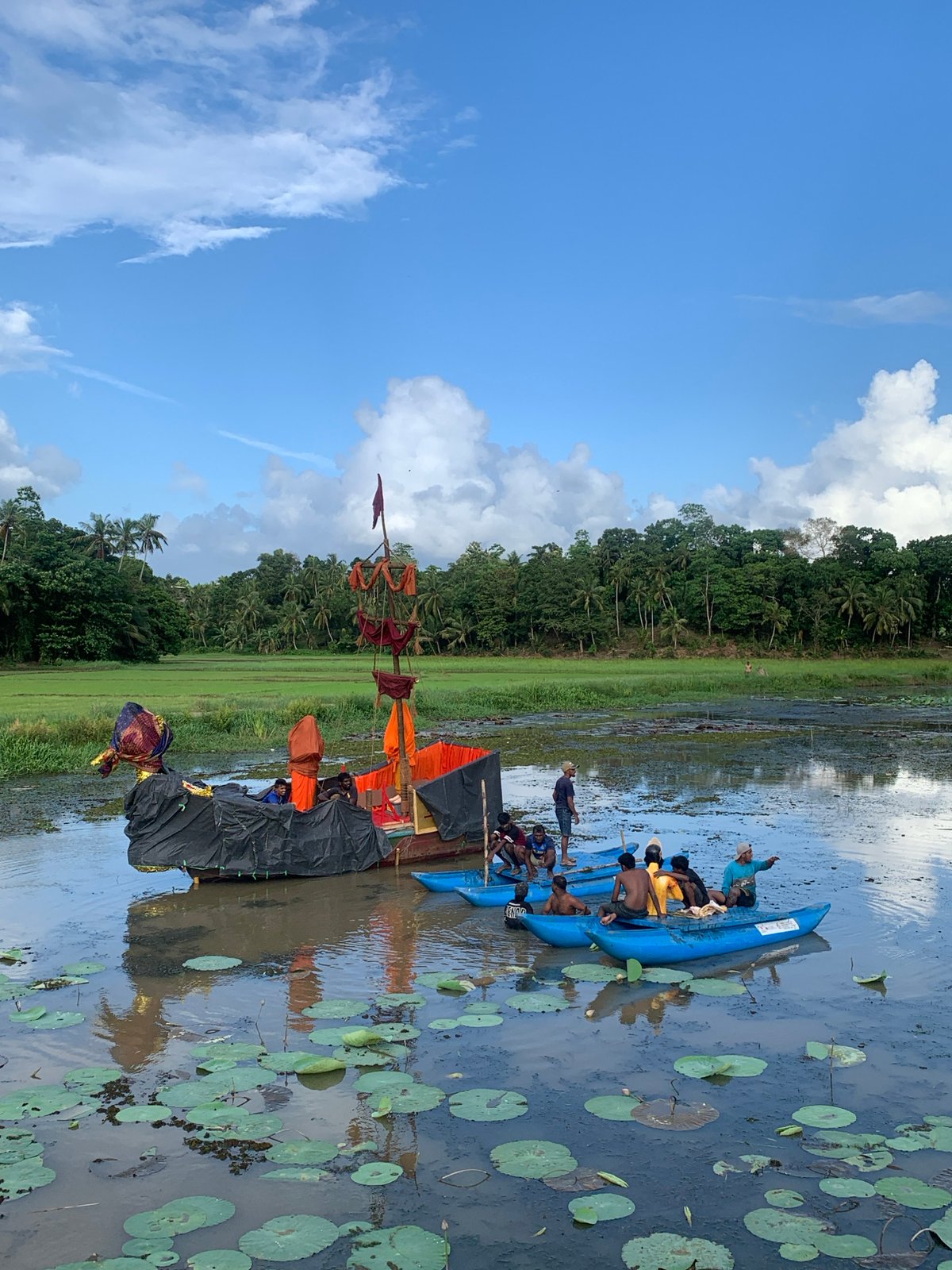 Decorated boats gather in lily pad waterway in Thihagoda