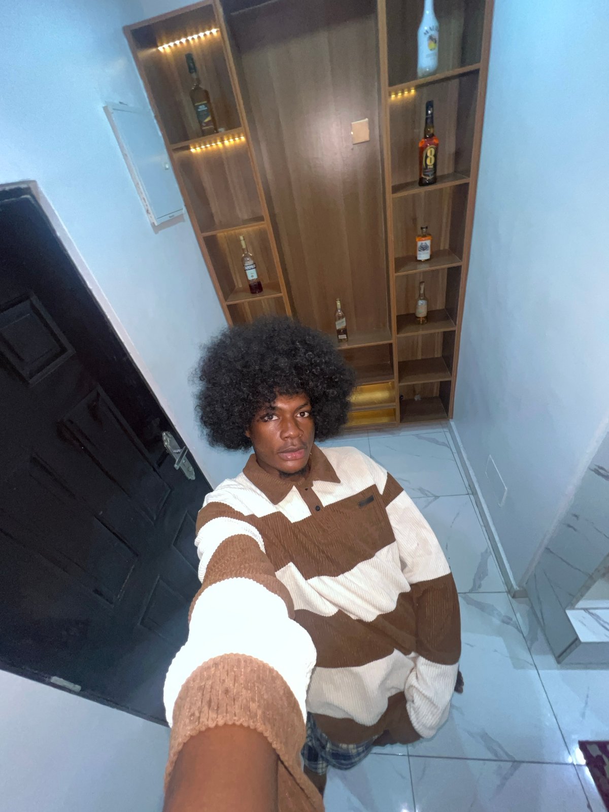 Man takes selfie in striped sweater in Nigeria