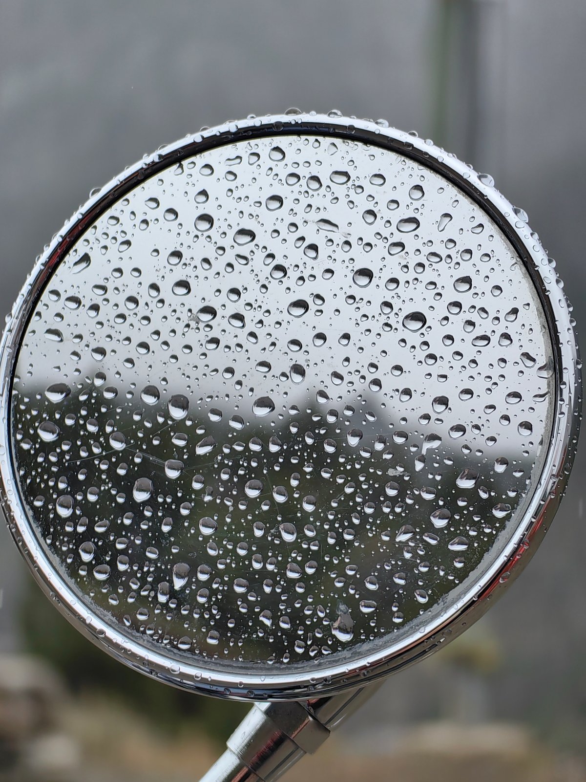 Wet day pit stop in Spiti Valley, motorcycles and mountain views.