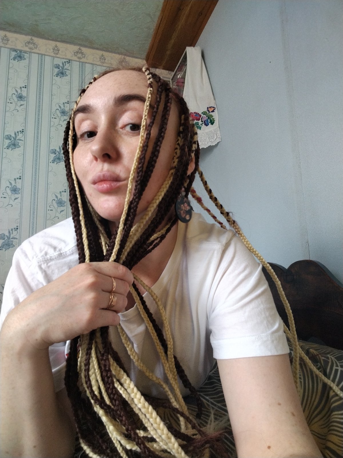 Woman with braided hair documented in residential setting, Яган