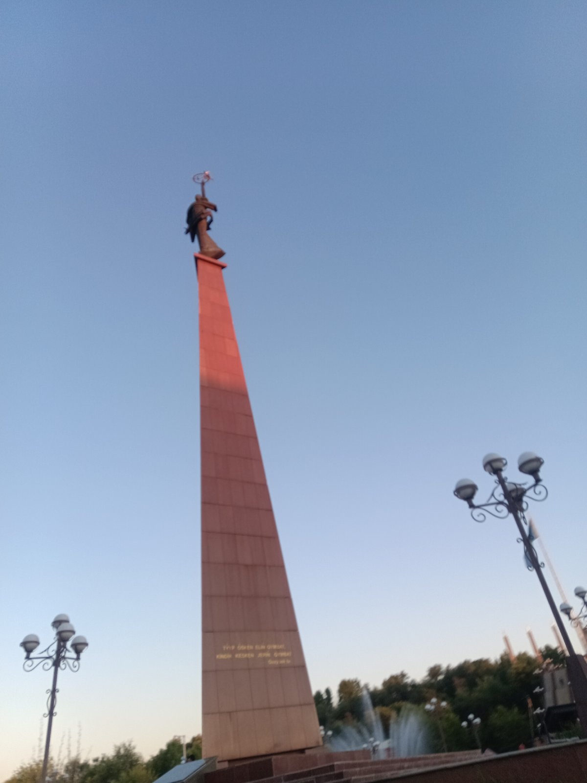 Driving through central Shymkent past monuments and fountains