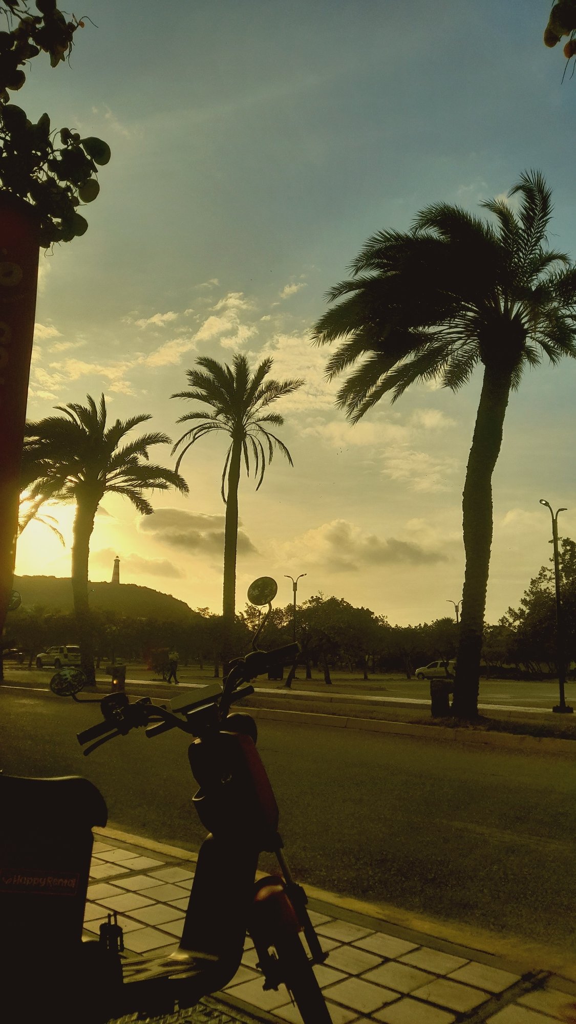 Rental scooters line sunset streets in Pedro González, Venezuela