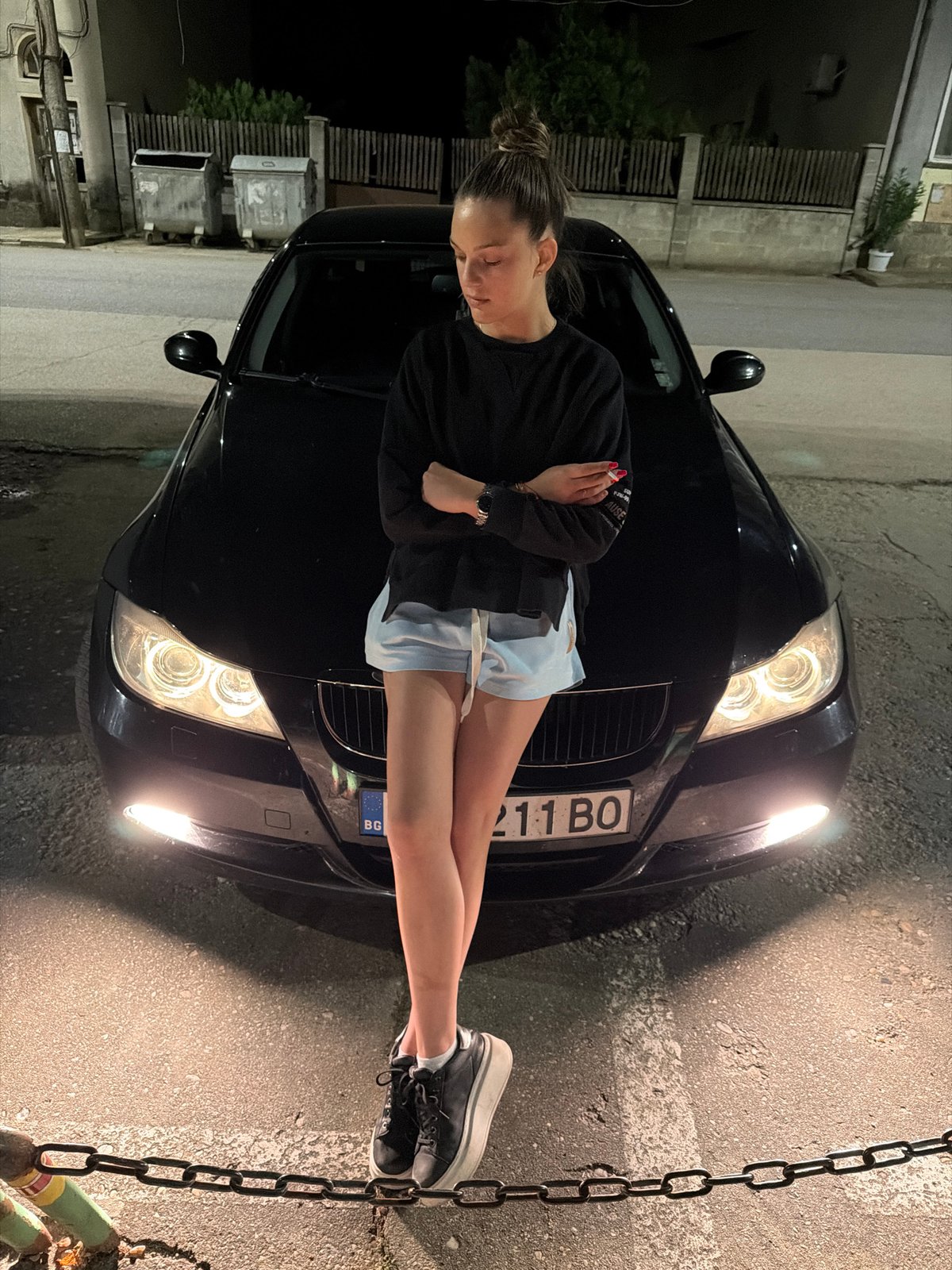 Woman poses on BMW hood in Kaleytsa, Bulgaria
