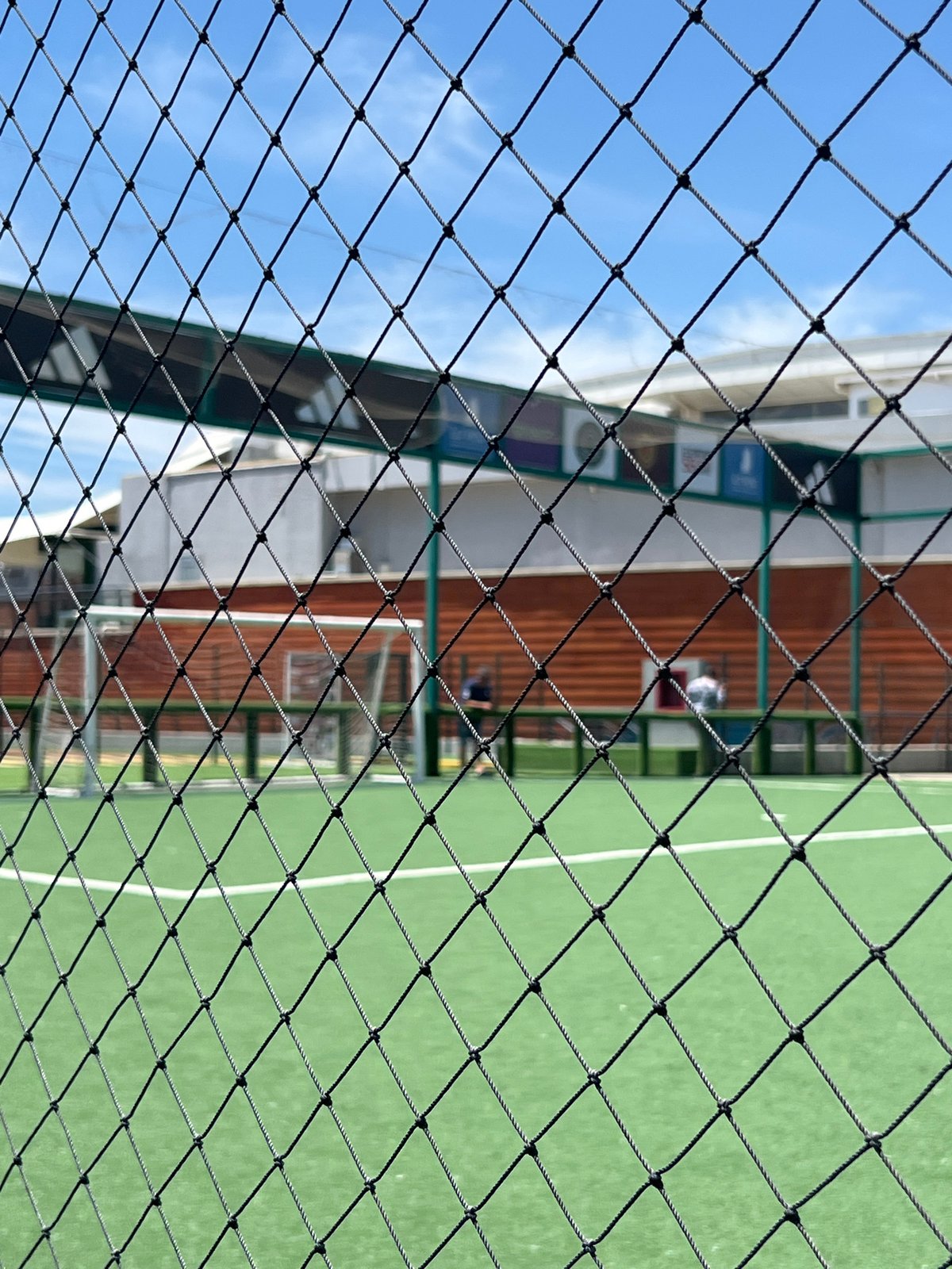 Observer documents view through safety mesh barrier