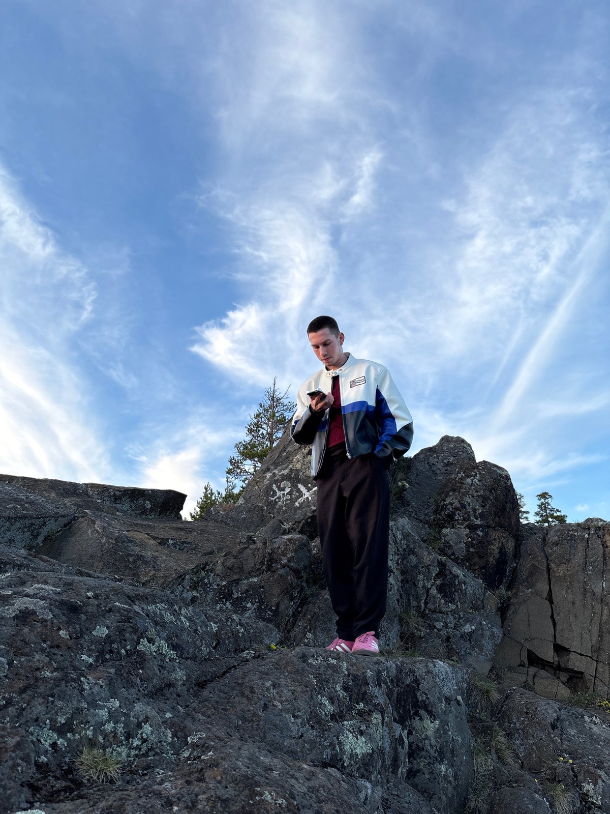 Person photographed on cliff overlooking Невон, Russia during midday