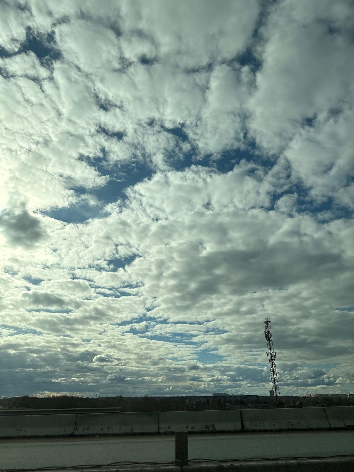 Cloudy skies observed over Кондратово, Russia with metal structure visible