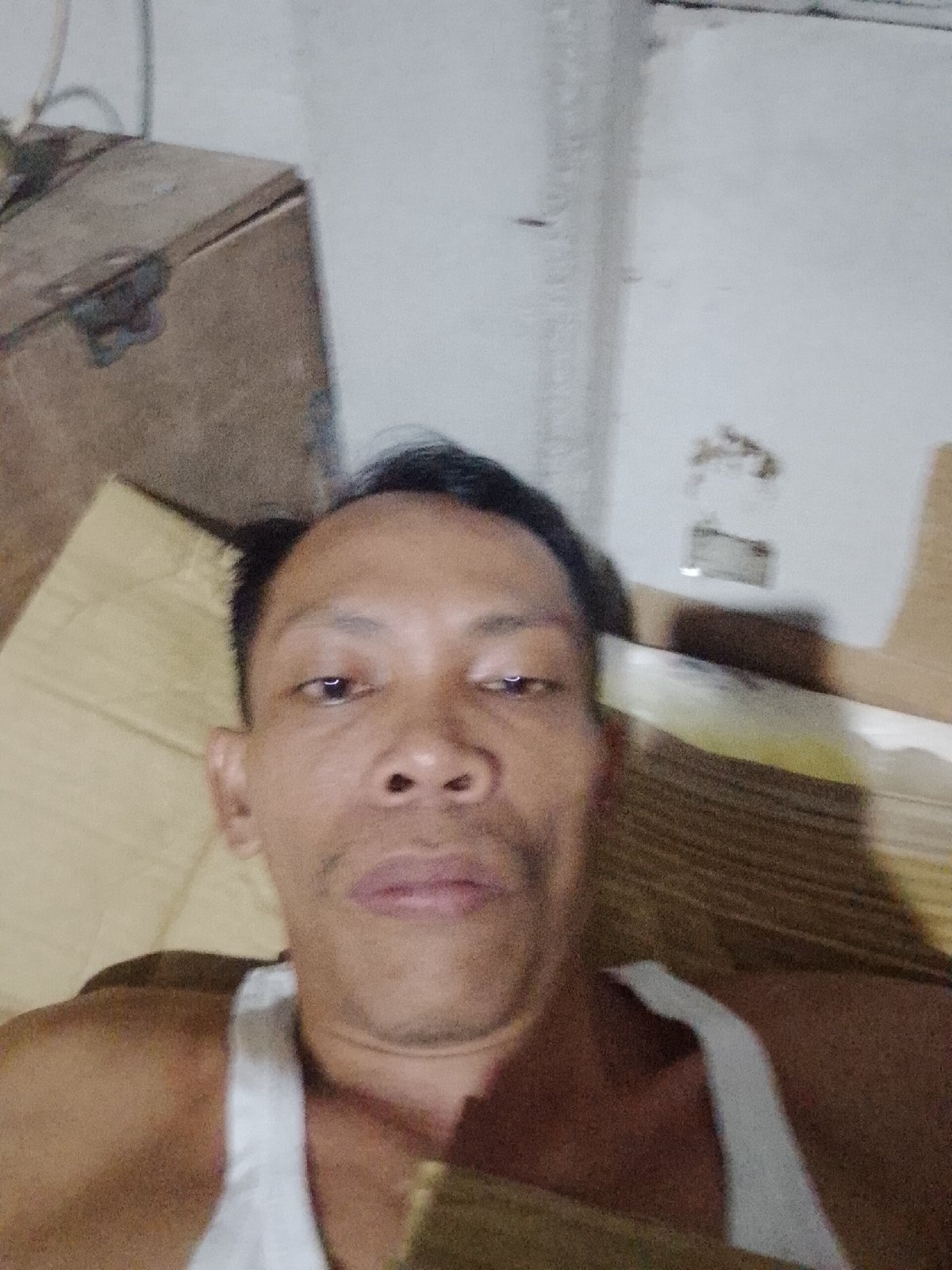 Man takes selfies indoors in Bukit Ketok, Indonesia