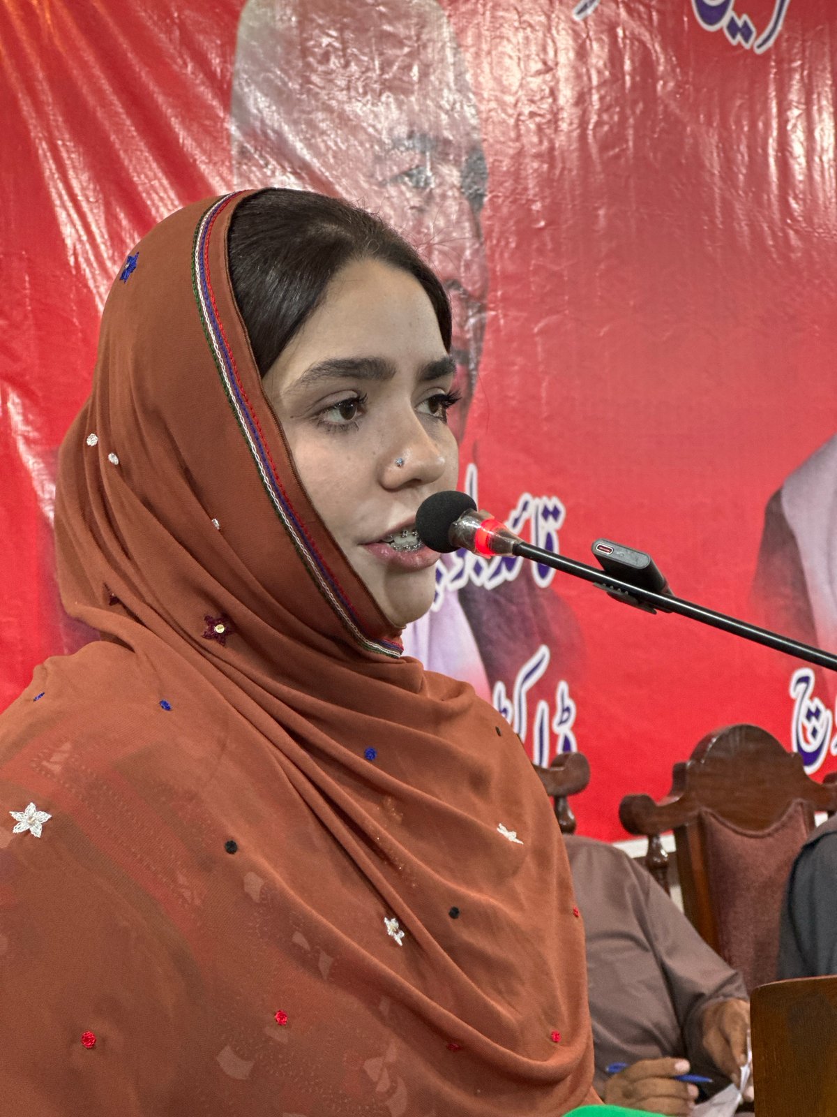 Indoor gathering with speakers and street scenes in Quetta