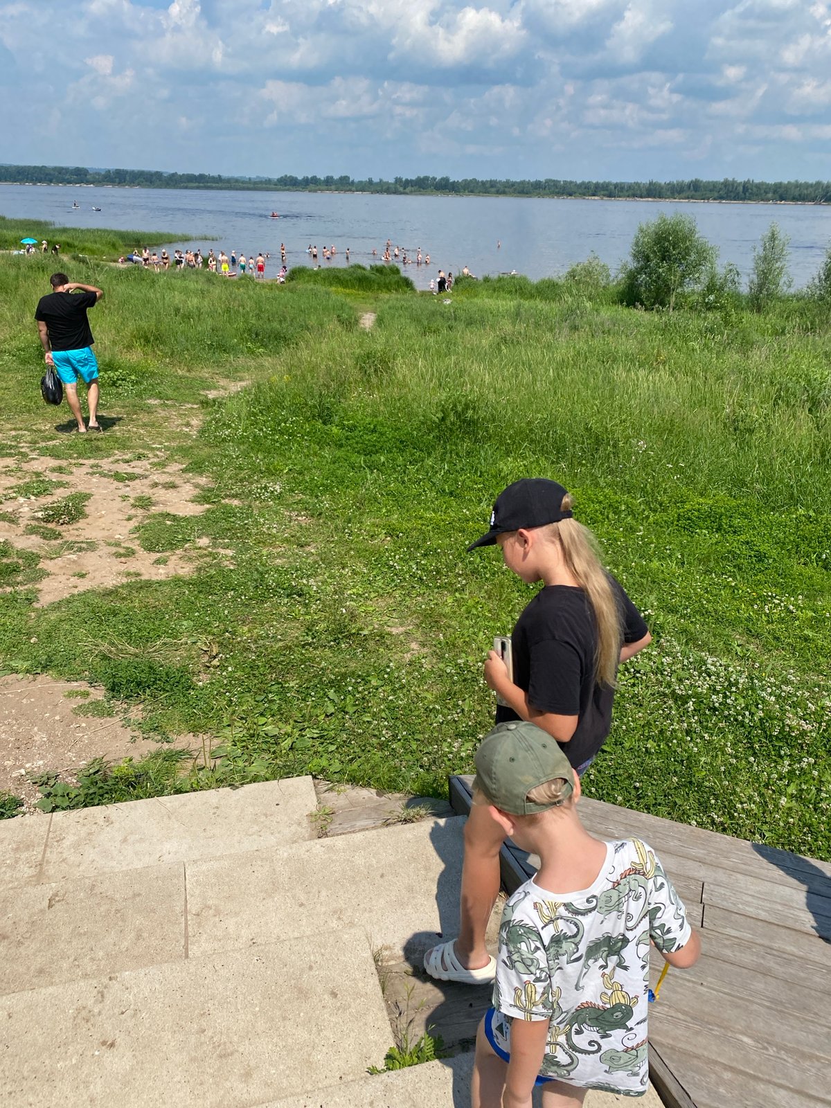 Summer day at a Russian riverside — swimming, strolling, and ships