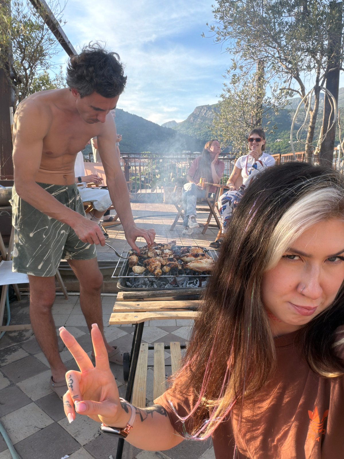 Friends gather for rooftop barbecue in Budva, Montenegro
