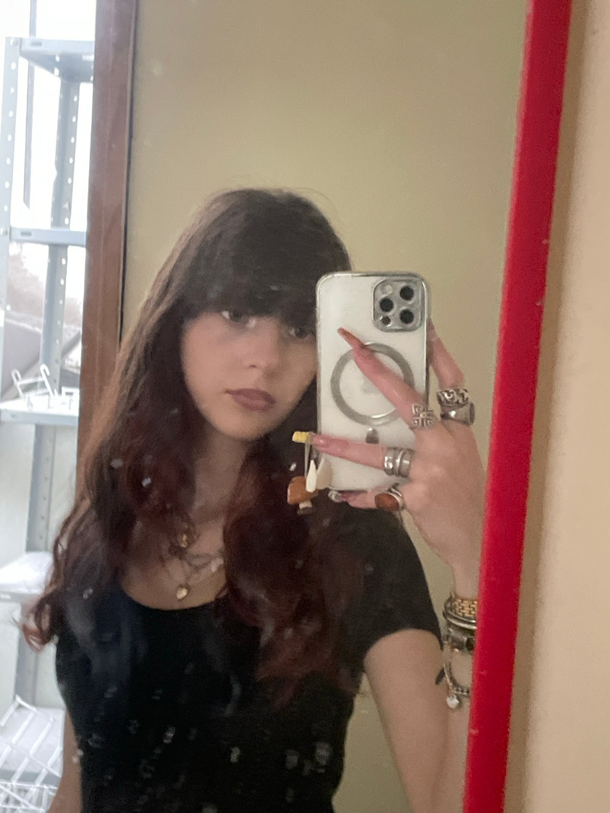 Woman takes mirror selfie in Raanana apartment