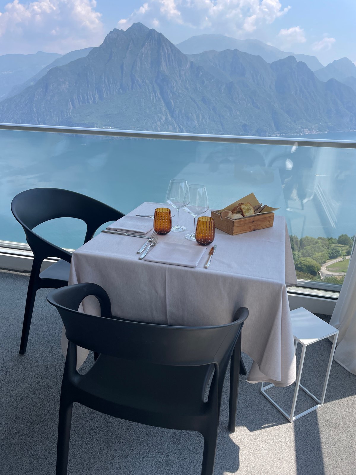 Romantic table setting overlooks mountain lake in Zorzino