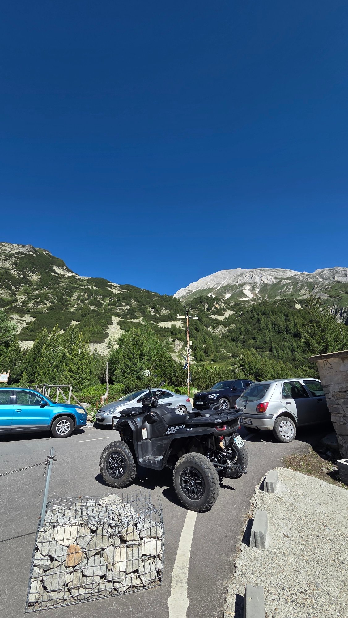 BMW and off-road Segway parked at a mountain stop in Bulgaria