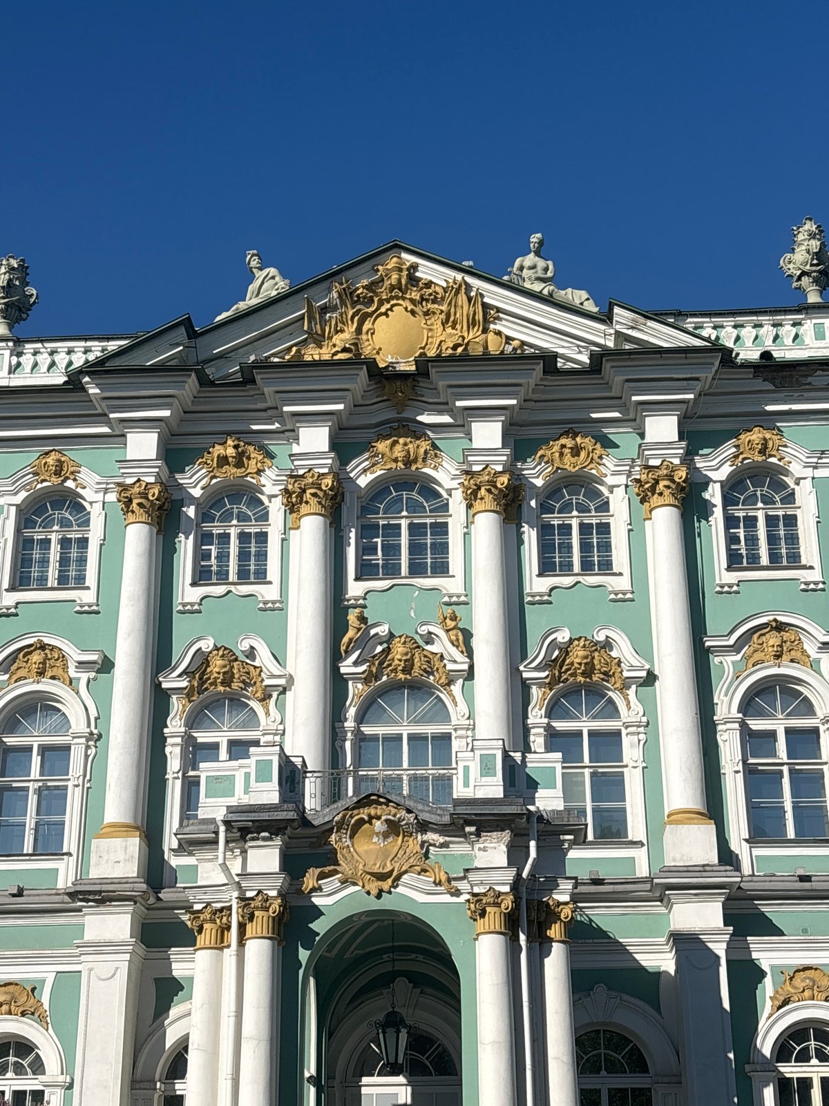 Sunny afternoon tourist activity at Saint Petersburg's Palace Square