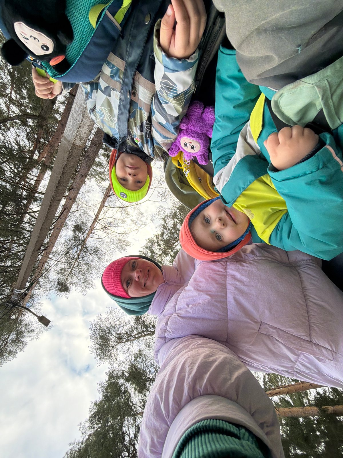Family moment captured near wooded waterside in Chaikovsky, Russia