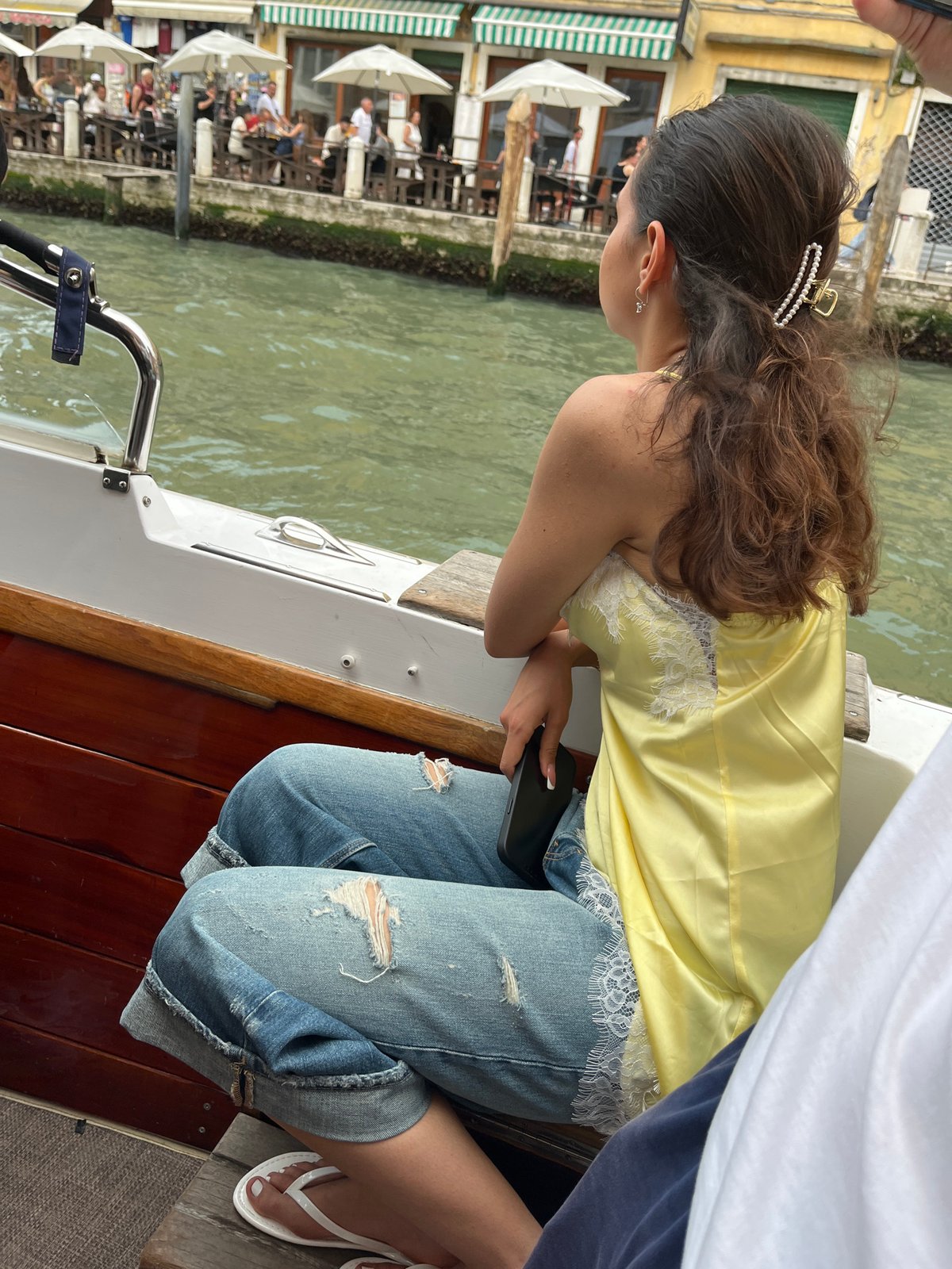 Motorboat with passengers cruises Venice canal near Rialto Bridge