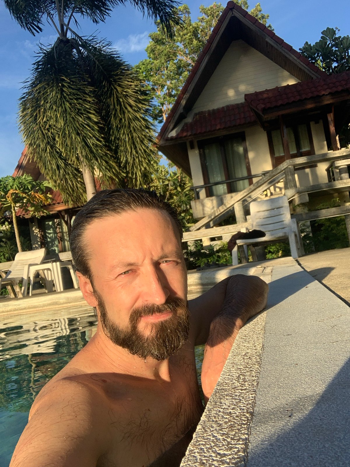 Poolside morning at a bungalow resort in Ban Bang Rak