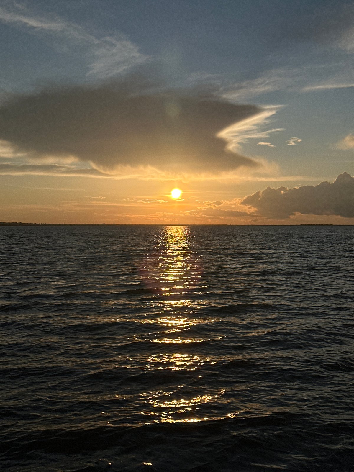 Golden sunset over dark water near Kokshetau, Kazakhstan