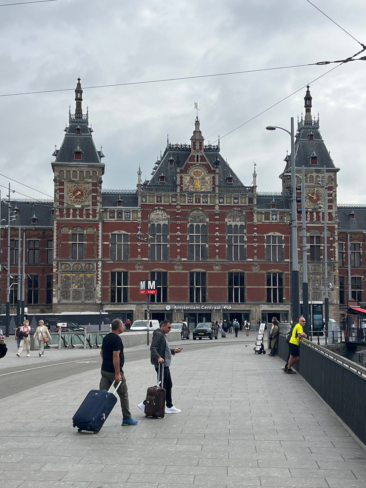 Amsterdam Centraal and canal boats on a June morning