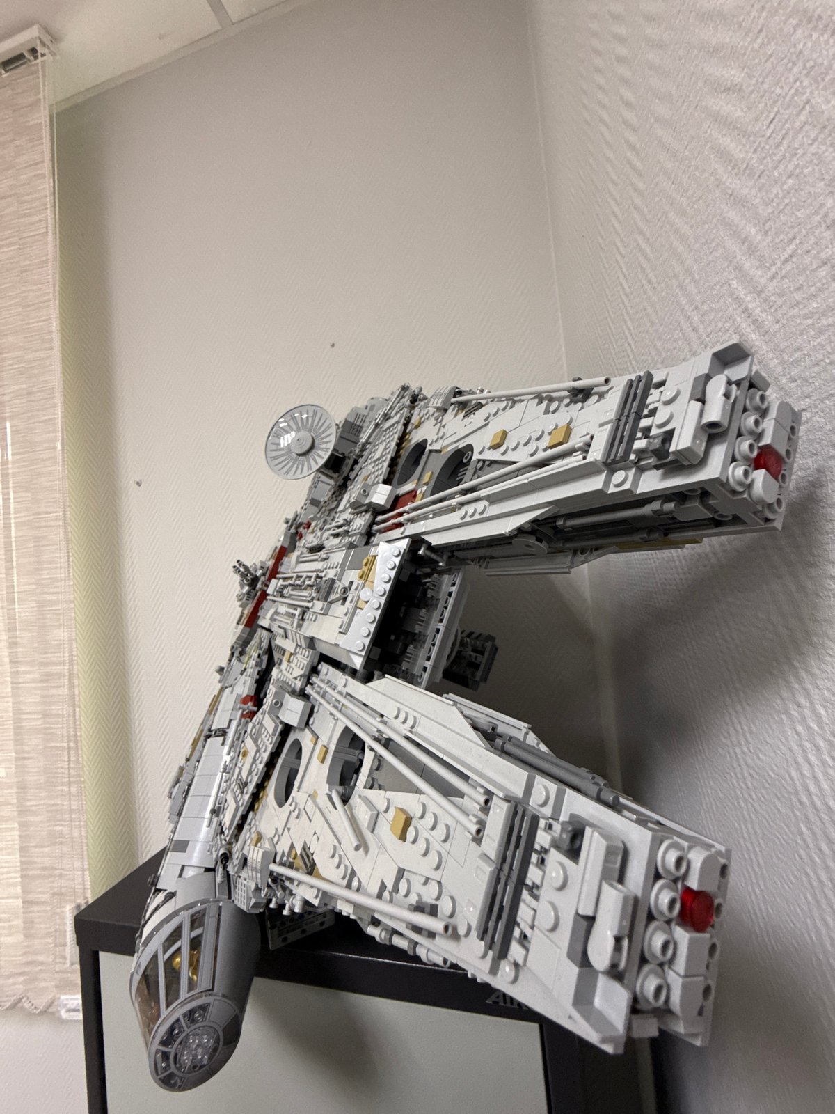 LEGO Millennium Falcon model displayed on wall in Krasnoyarsk